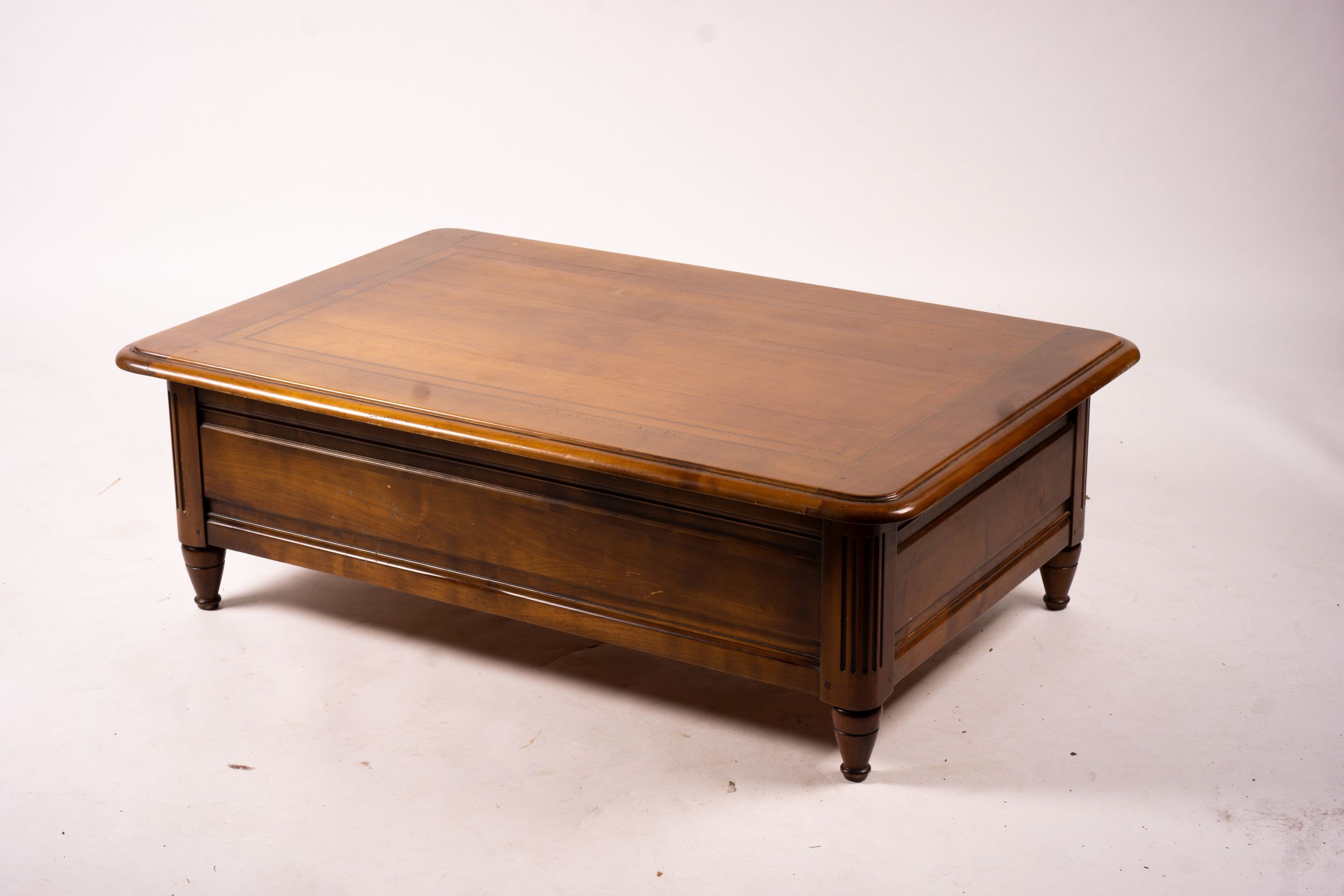 A reproduction rectangular walnut coffee table with rising top enclosing a wine bottle storage interior, length 130cm, depth 85cm, height 41cm